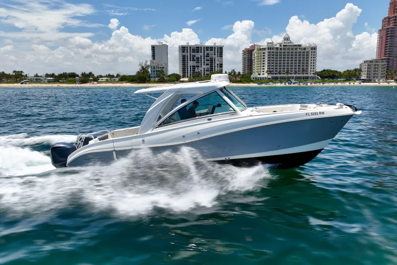  Yacht Photos Pics 2018 World Cat 320 DC cruising on ocean near city skyline.