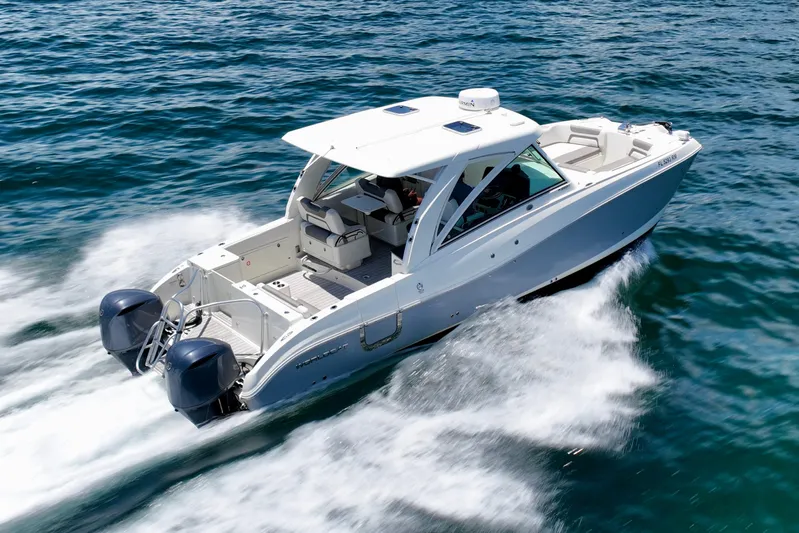  Yacht Photos Pics 2018 World Cat 320 DC cruising on open water, showcasing dual engines and sleek design.