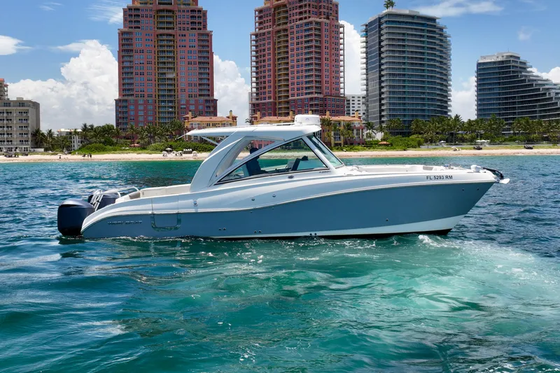  Yacht Photos Pics 2018 World Cat 320 DC boat on water with city skyline in background.