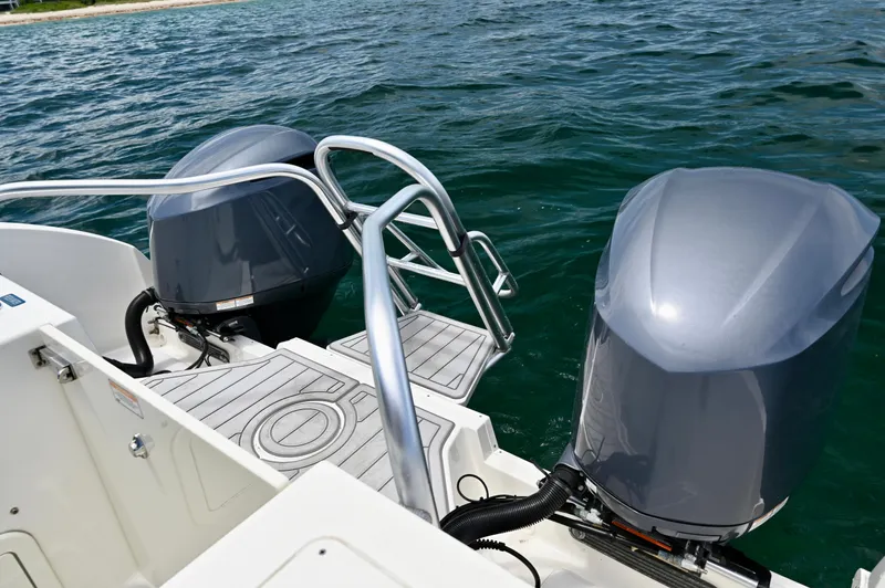  Yacht Photos Pics 2018 World Cat 320 DC boat with dual outboard motors on a calm sea.