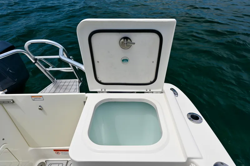 Yacht Photos Pics Open storage compartment on 2018 World Cat 320 DC boat, near water.