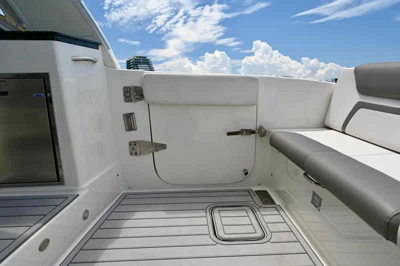  Yacht Photos Pics 2018 World Cat 320 DC boat interior with seating and storage, under a clear blue sky.