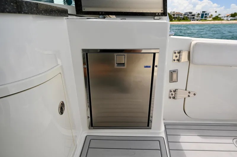  Yacht Photos Pics Stainless steel refrigerator on 2018 World Cat 320 DC boat, with ocean view in background.