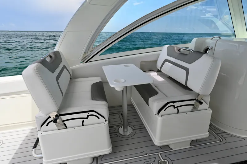  Yacht Photos Pics 2018 World Cat 320 DC boat interior with seating and table, ocean view.