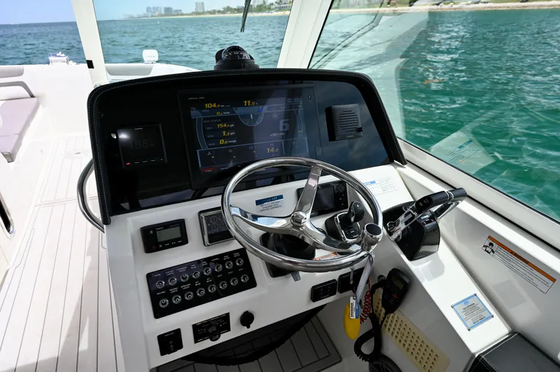  Yacht Photos Pics Cockpit of 2018 World Cat 320 DC boat with steering wheel and control panel.