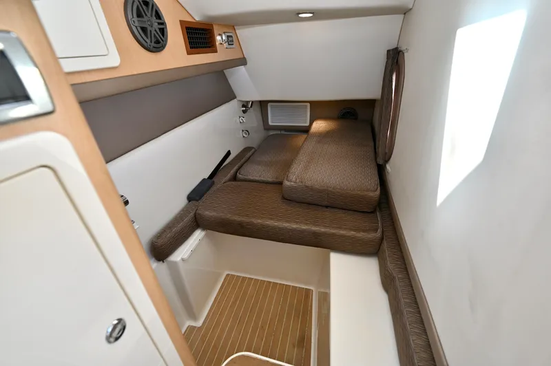  Yacht Photos Pics 2018 World Cat 320 DC cabin interior with cushioned seating and wooden flooring.