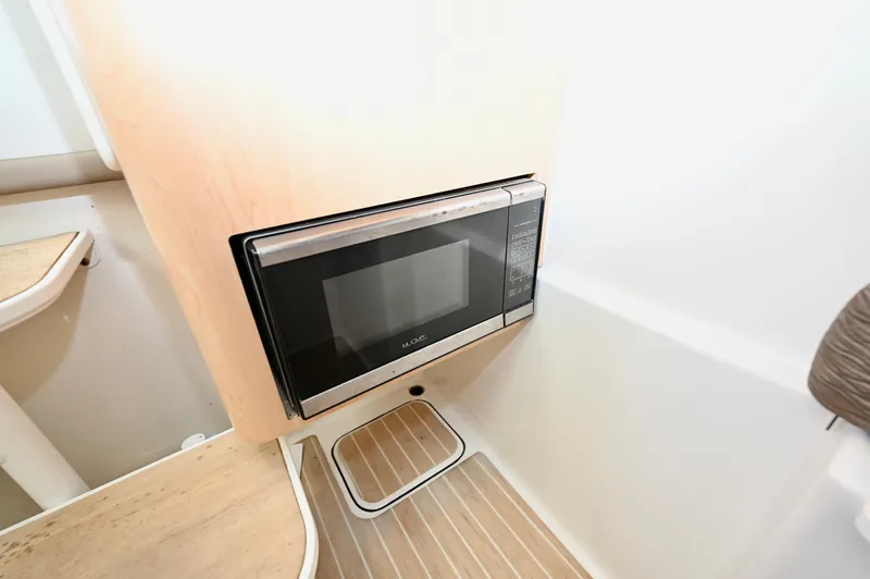  Yacht Photos Pics Microwave in 2018 World Cat 320 DC boat interior, featuring wood accents and modern design.