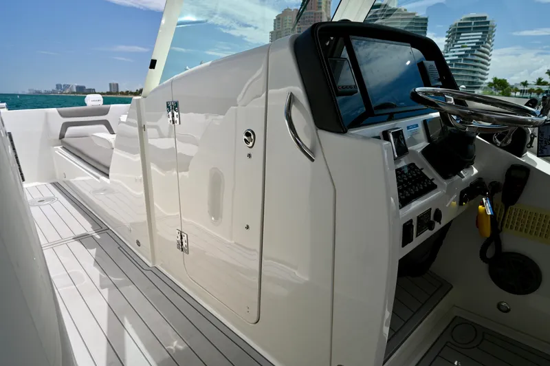  Yacht Photos Pics 2018 World Cat 320 DC boat interior with sleek dashboard and modern steering wheel.