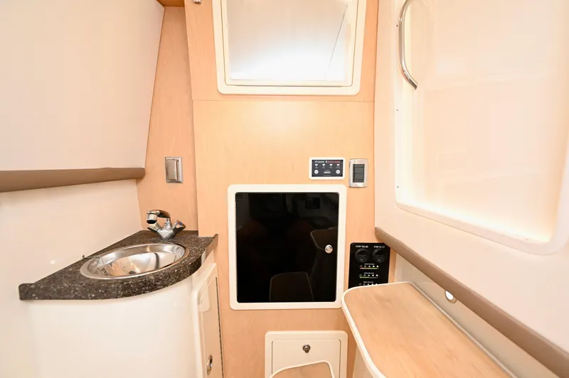  Yacht Photos Pics Interior of 2018 World Cat 320 DC boat featuring a compact sink and control panel.