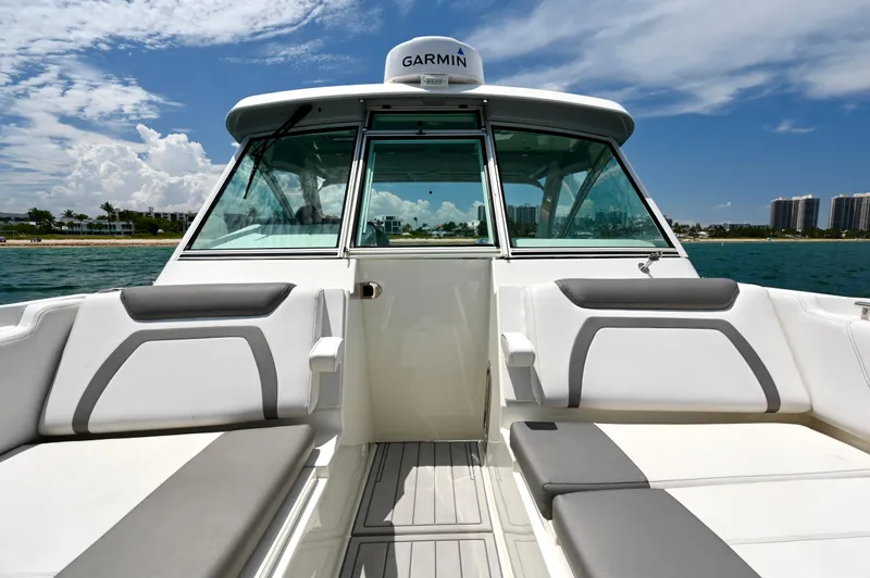  Yacht Photos Pics 2018 World Cat 320 DC boat interior with seating, ocean view, and clear sky.
