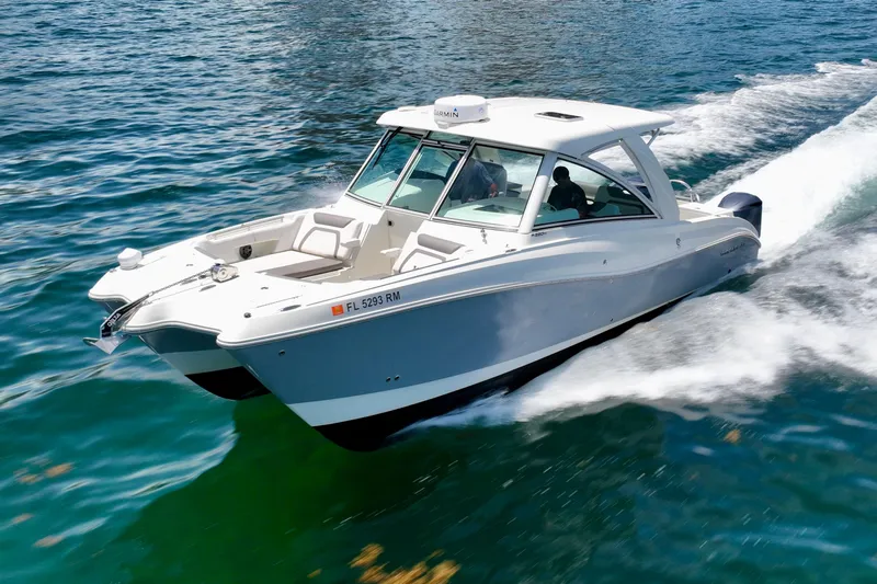  Yacht Photos Pics 2018 World Cat 320 DC boat cruising on clear blue water.