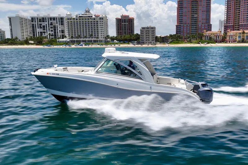  Yacht Photos Pics 2018 World Cat 320 DC cruising near a coastal city skyline.