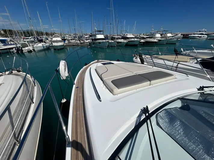  Yacht Photos Pics 2020 Princess V50 yacht docked in a marina with clear blue water.