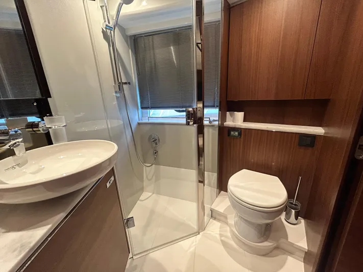  Yacht Photos Pics Luxurious bathroom in 2020 Princess V50 yacht with modern fixtures and wooden accents.