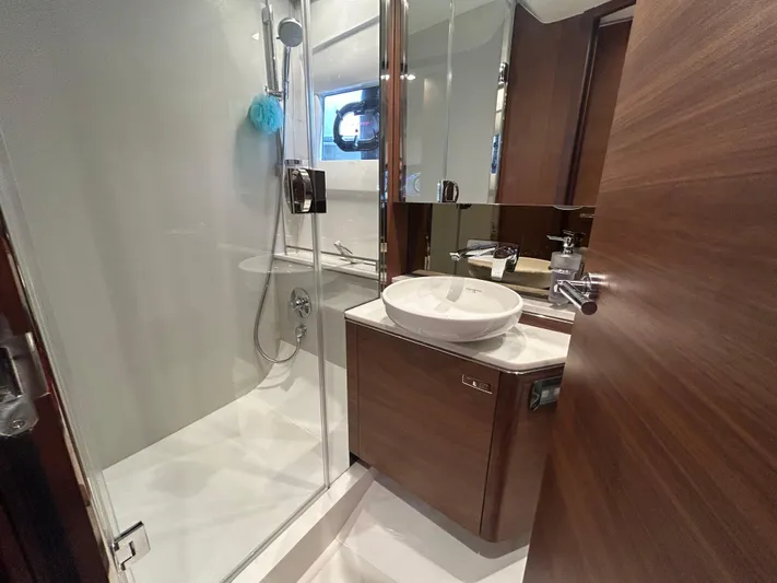  Yacht Photos Pics Luxurious bathroom in 2020 Princess V50 yacht with modern fixtures and elegant wood finishes.