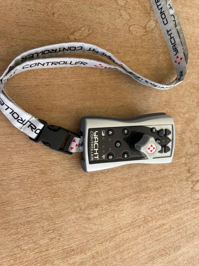  Yacht Photos Pics Remote control for yacht with lanyard on wooden surface, Princess V50 2020 model.