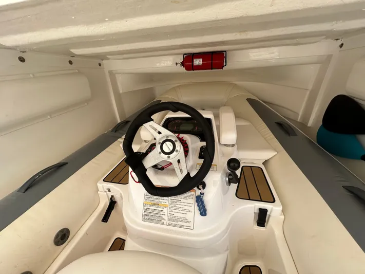  Yacht Photos Pics Interior of a 2020 Princess V50 boat showing steering wheel and controls.