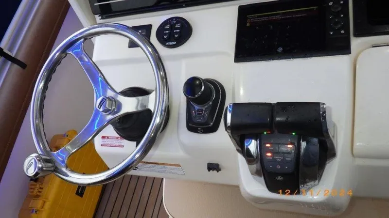  Yacht Photos Pics 2018 Scout 350 LXF boat helm with steering wheel and controls.