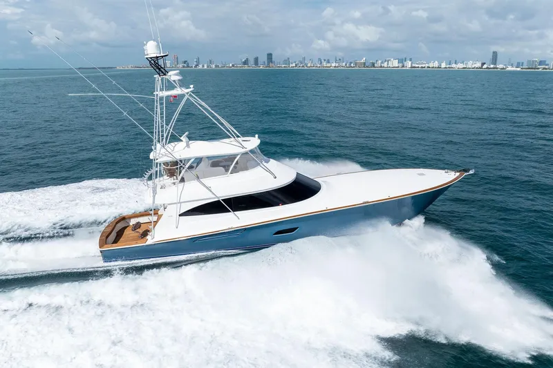  Yacht Photos Pics 2018 Viking 80 Convertible yacht cruising on open water near city skyline.
