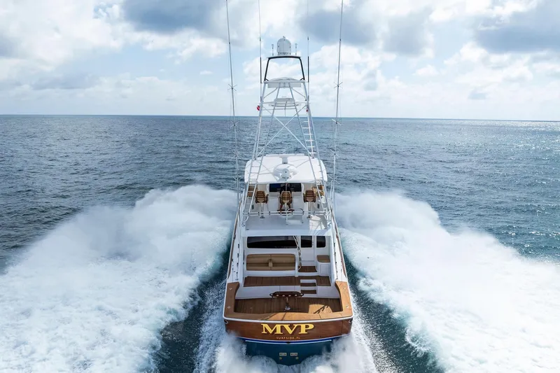  Yacht Photos Pics 2018 Viking 80 Convertible yacht cruising on open ocean under cloudy sky.