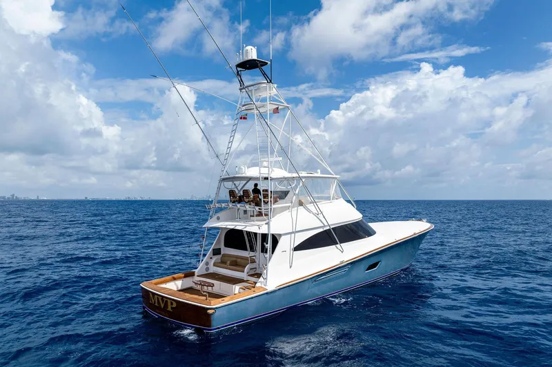  Yacht Photos Pics 2018 Viking 80 Convertible yacht cruising on open ocean under blue sky.