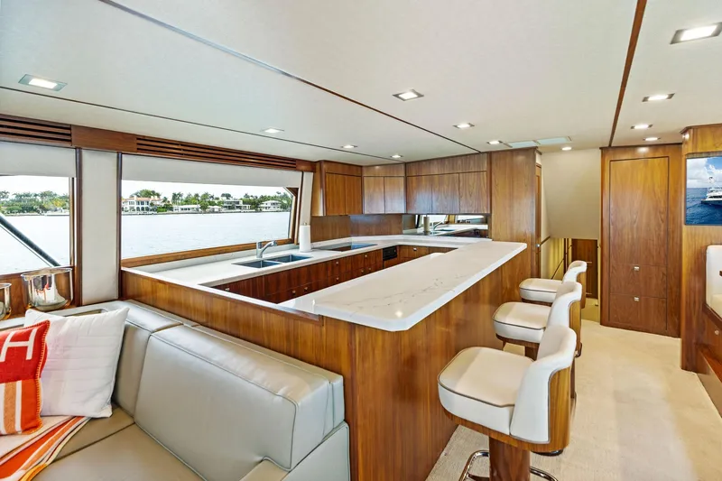  Yacht Photos Pics Luxurious interior of 2018 Viking 80 Convertible yacht with modern kitchen and seating area.