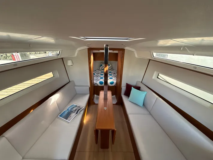  Yacht Photos Pics Interior of 2024 Jeanneau Sun Odyssey 350 sailboat with modern seating and natural light.