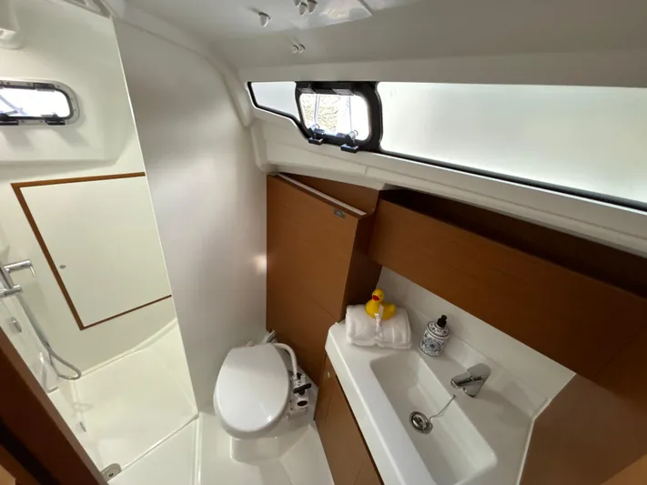  Yacht Photos Pics 2024 Jeanneau Sun Odyssey 350 bathroom with modern fixtures and natural light.