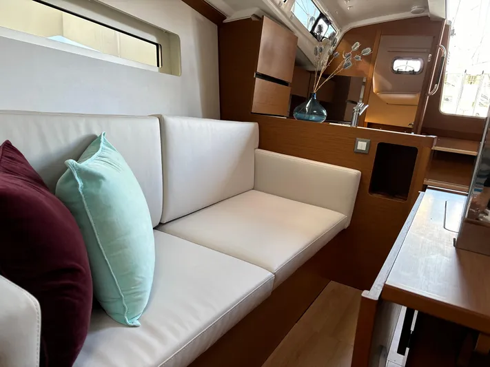  Yacht Photos Pics 2024 Jeanneau Sun Odyssey 350 interior with modern seating and stylish decor.