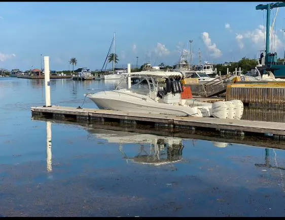  Yacht Photos Pics 2006 Hydra-Sports 33 Vx boat docked at a marina on a calm day.