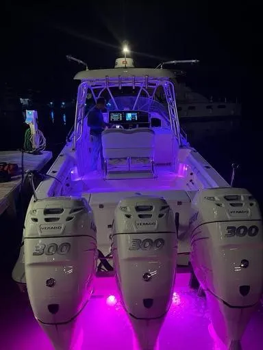  Yacht Photos Pics 2006 Hydra-Sports 33 Vx boat with triple 300hp engines illuminated at night.