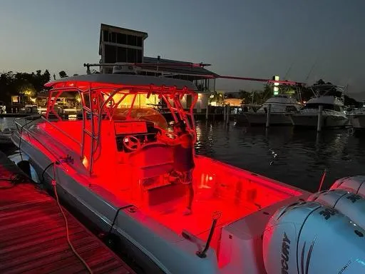  Yacht Photos Pics 2006 Hydra-Sports 33 Vx boat illuminated with red lights at a marina during dusk.