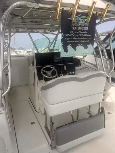  Yacht Photos Pics 2006 Hydra-Sports 33 Vx yacht cockpit with steering wheel and broker sign.