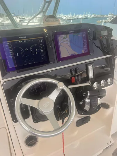  Yacht Photos Pics 2006 Hydra-Sports 33 Vx boat dashboard with navigation screens and steering wheel.