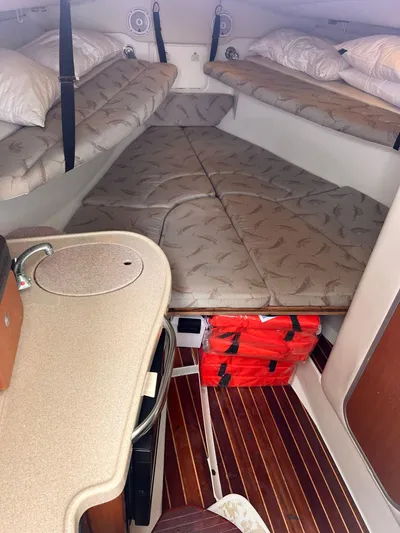  Yacht Photos Pics Interior cabin of a 2006 Hydra-Sports 33 Vx boat with cushioned sleeping area.
