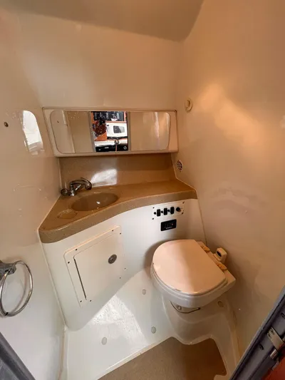  Yacht Photos Pics 2006 Hydra-Sports 33 Vx boat bathroom with sink, toilet, and mirror.