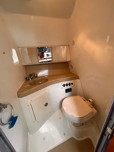  Yacht Photos Pics 2006 Hydra-Sports 33 Vx boat bathroom with sink, mirror, and toilet.
