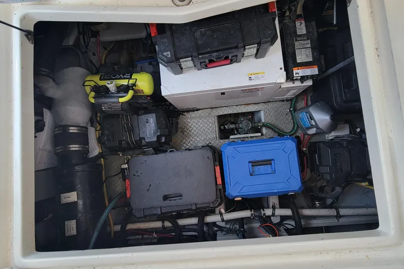 'perrydise' Yacht Photos Pics Engine compartment of a 2007 Meridian 341 Sedan, showcasing various equipment and storage boxes.