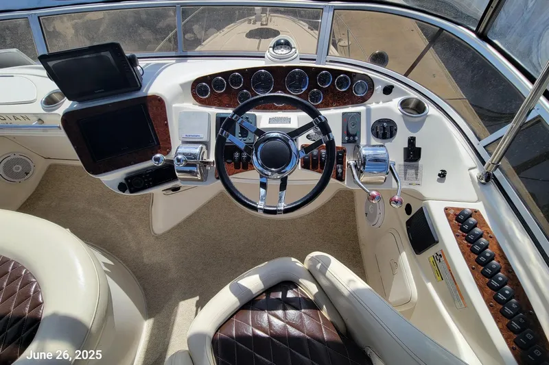 'perrydise' Yacht Photos Pics Helm of 2007 Meridian 341 Sedan with modern controls and leather seating.