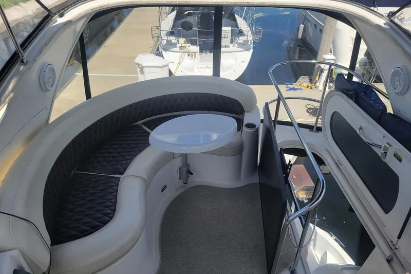'perrydise' Yacht Photos Pics 2007 Meridian 341 Sedan yacht interior with curved seating and table, docked at marina.