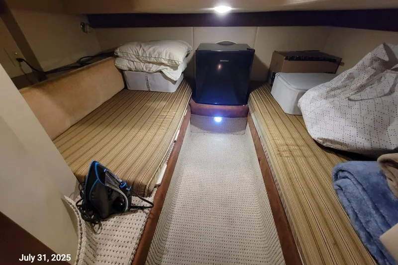 'perrydise' Yacht Photos Pics 2007 Meridian 341 Sedan cabin interior with beds, storage, and a mini fridge.