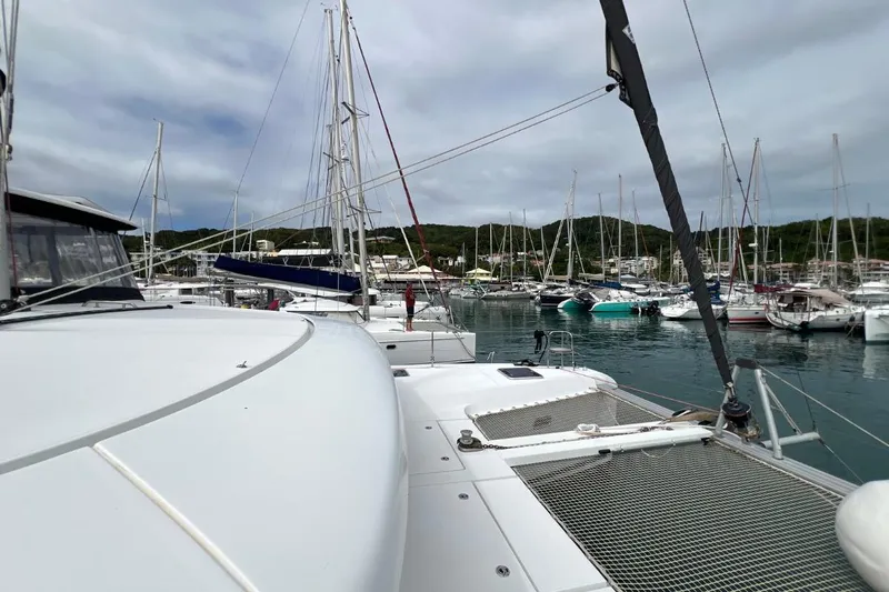 Mocean Yacht Photos Pics 2017 Lagoon 42 catamaran docked in a marina with surrounding sailboats.