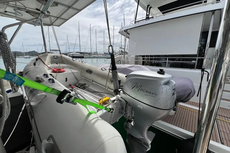 Mocean Yacht Photos Pics 2017 Lagoon 42 yacht with inflatable dinghy and outboard motor, docked at marina.