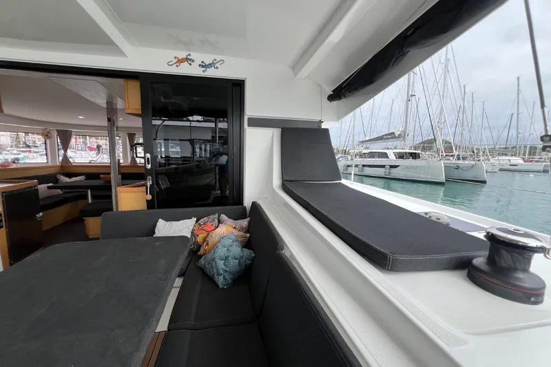 Mocean Yacht Photos Pics Interior view of 2017 Lagoon 42 catamaran with cozy seating and marina backdrop.