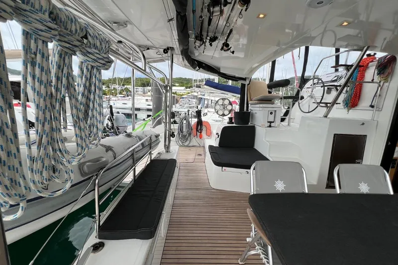 Mocean Yacht Photos Pics 2017 Lagoon 42 catamaran interior with seating, ropes, and steering wheel in a marina setting.