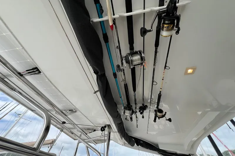 Mocean Yacht Photos Pics Fishing rods stored on a 2017 Lagoon 42 catamaran's ceiling, with visible stainless steel railings.