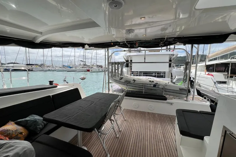 Mocean Yacht Photos Pics Spacious deck of 2017 Lagoon 42 catamaran in marina, featuring comfortable seating and scenic views.