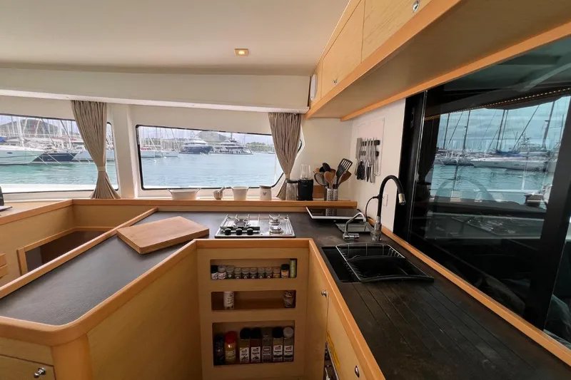 Mocean Yacht Photos Pics Modern kitchen interior of 2017 Lagoon 42 catamaran with marina view.