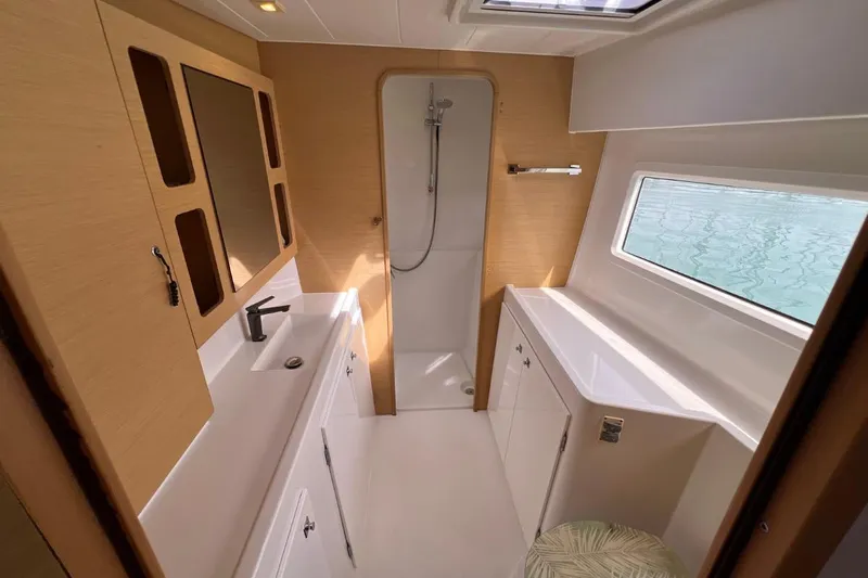 Mocean Yacht Photos Pics Modern bathroom interior of 2017 Lagoon 42 yacht with shower and window view.