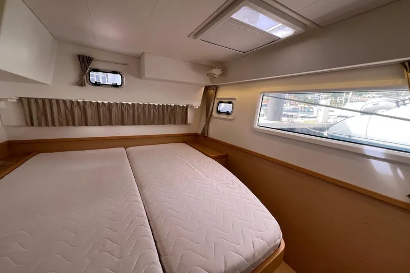 Mocean Yacht Photos Pics Interior cabin of 2017 Lagoon 42 catamaran with double bed and windows.